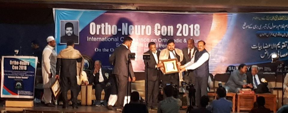 Principal receiving award at Ortho-Neuro International Conference